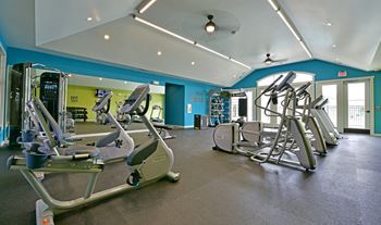 A room filled with lots of different types of exercise equipment